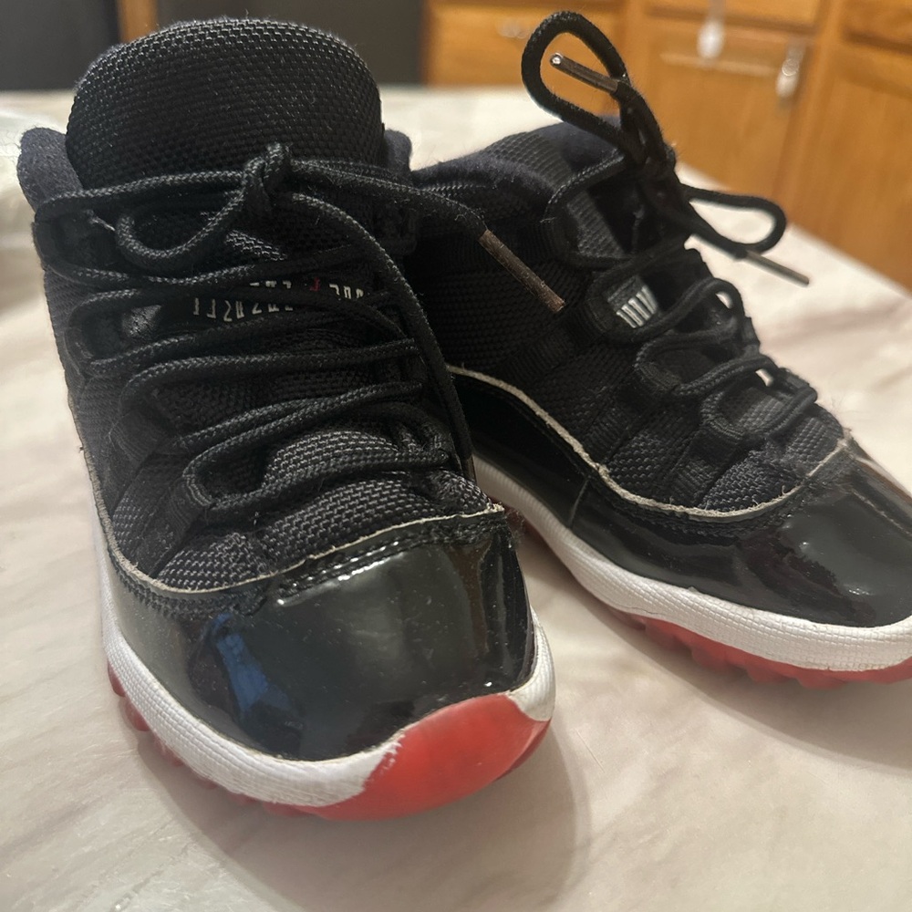 Jordan Black and Red Sneakers with Patent Leather and Mid-Top Design